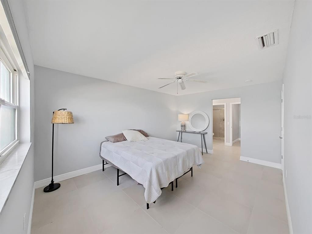 7 Dunoon Place, Unit 104 Dunedin, FL 34698 - Photo 26 of 45 a spacious bedroom with a bed and window