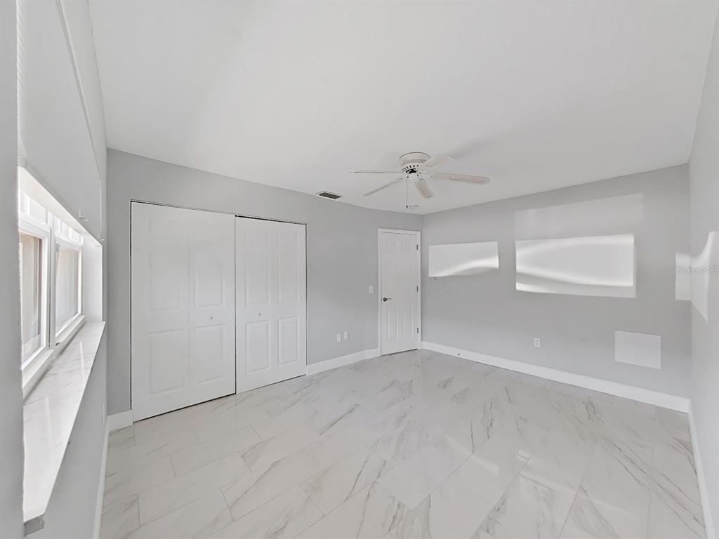 7 Dunoon Place, Unit 104 Dunedin, FL 34698 - Photo 35 of 45 a view of an empty room with a window