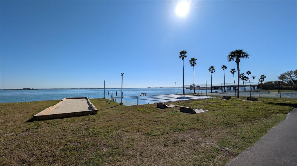 7 Dunoon Place, Unit 104 Dunedin, FL 34698 - Photo 40 of 45 a view of a swimming pool with a yard