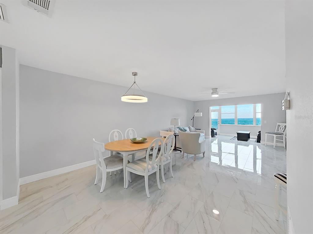 7 Dunoon Place, Unit 104 Dunedin, FL 34698 - Photo 10 of 45 a view of a dining room with furniture and wooden floor
