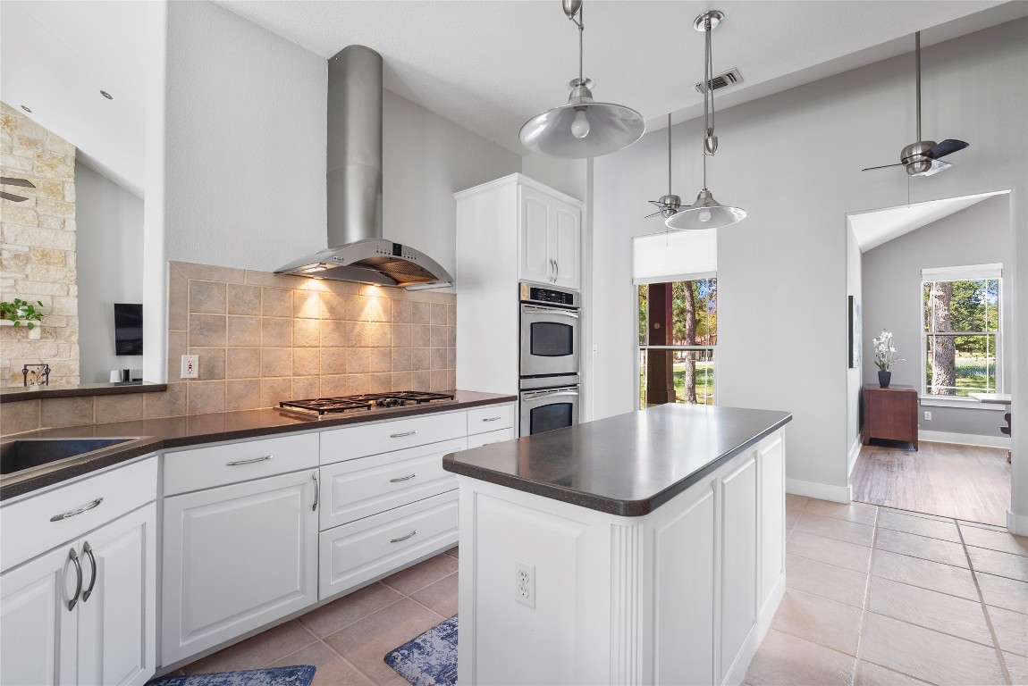 119 Maple Leaf Trail Elgin, TX 78621 - Photo 11 of 40 a kitchen with stainless steel appliances granite countertop a sink a refrigerator and a stove