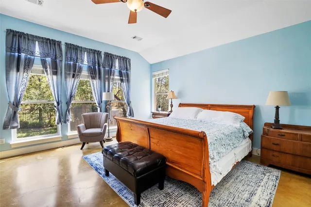 a bedroom with furniture and a large window