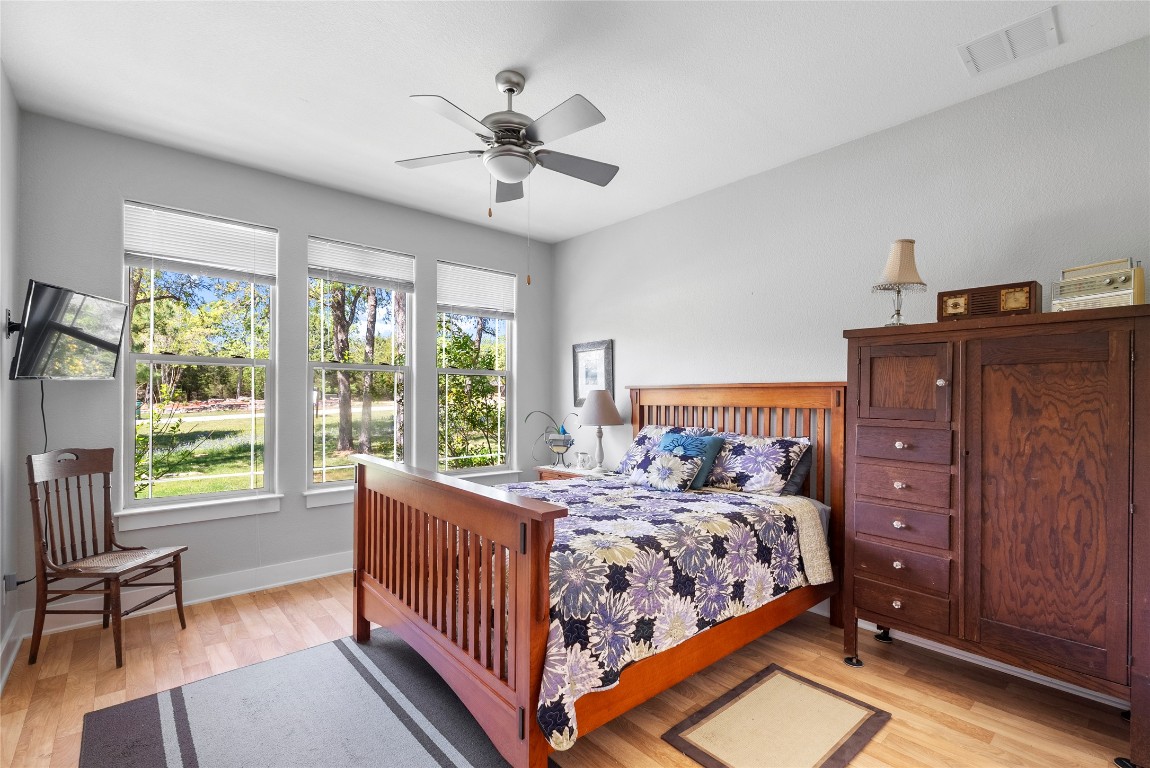119 Maple Leaf Trail Elgin, TX 78621 - Photo 20 of 40 a bedroom with a bed and a chandelier