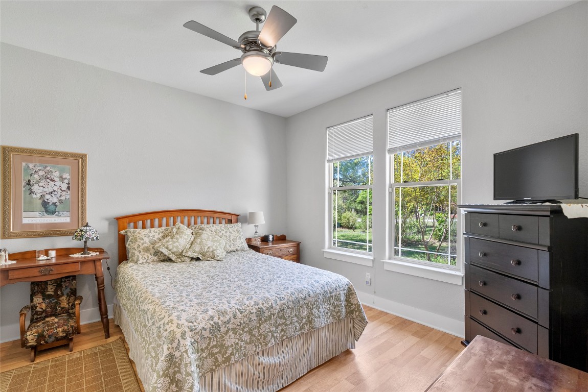119 Maple Leaf Trail Elgin, TX 78621 - Photo 21 of 40 a bedroom with a bed and a flat screen tv