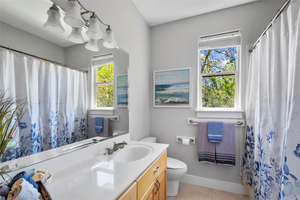 119 Maple Leaf Trail Elgin, TX 78621 - Photo 22 of 40 a bathroom with a sink a toilet and a mirror