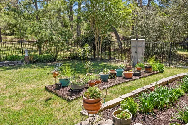 a view of a backyard with furniture and garden