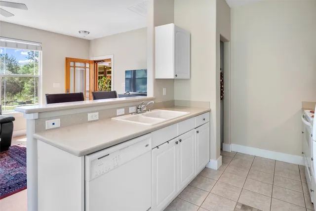 a kitchen with a sink cabinets and window