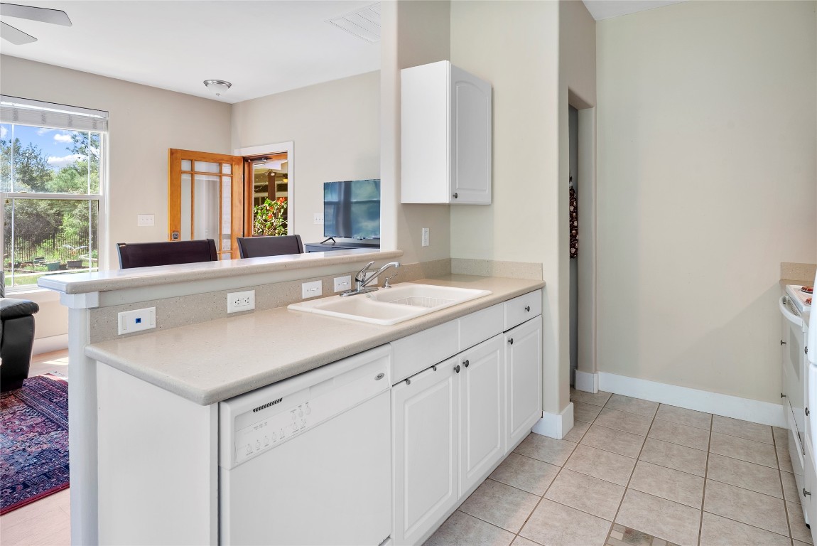 119 Maple Leaf Trail Elgin, TX 78621 - Photo 30 of 40 a kitchen with a sink cabinets and window