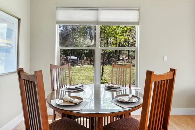 a dining room with furniture wooden floor and a potted plant