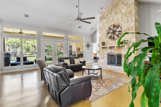 a living room with fireplace furniture and a large window
