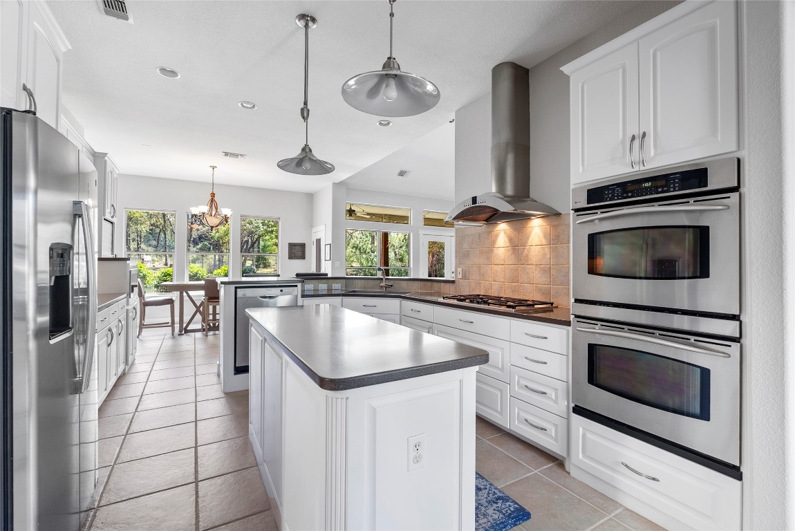 119 Maple Leaf Trail Elgin, TX 78621 - Photo 8 of 40 a kitchen with stainless steel appliances granite countertop a stove a sink and a refrigerator