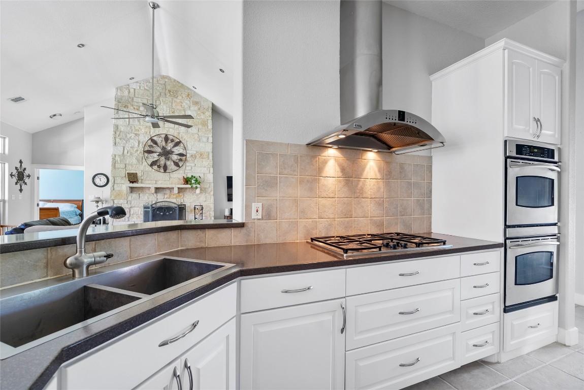 119 Maple Leaf Trail Elgin, TX 78621 - Photo 10 of 40 a kitchen with granite countertop a sink stove and cabinets