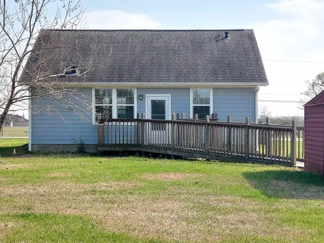 a view of a house with a yard and deck