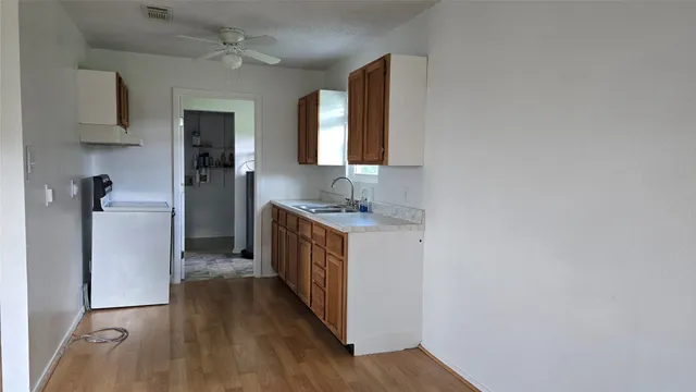 a kitchen with sink and refrigerator