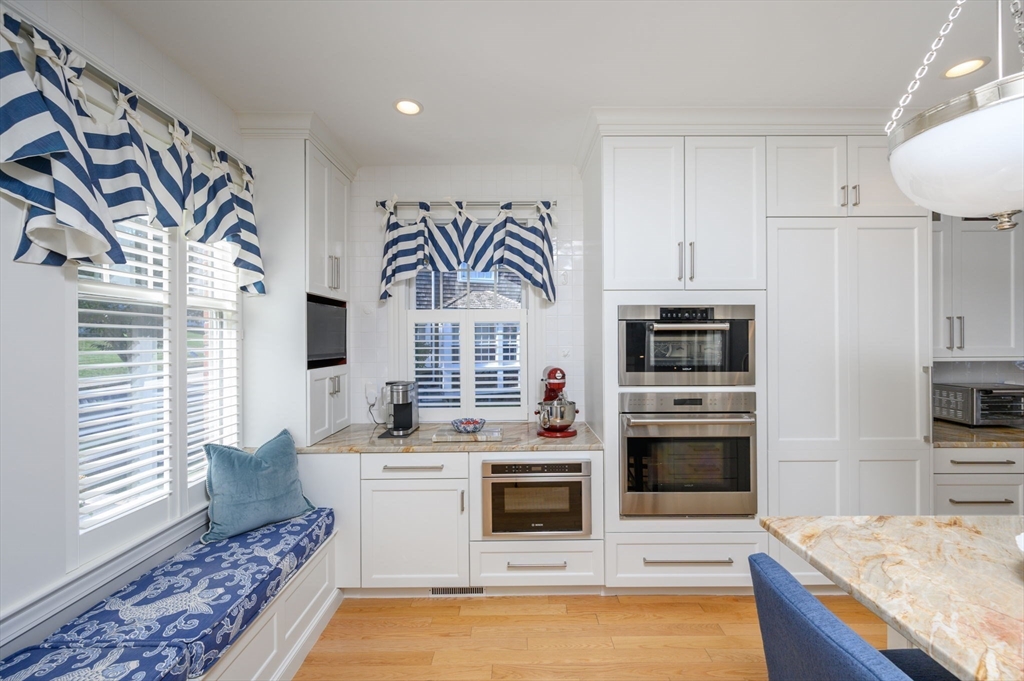 171 Otis Street Hingham, MA 02043 - Photo 11 of 29 a kitchen with stainless steel appliances a stove a sink and a refrigerator
