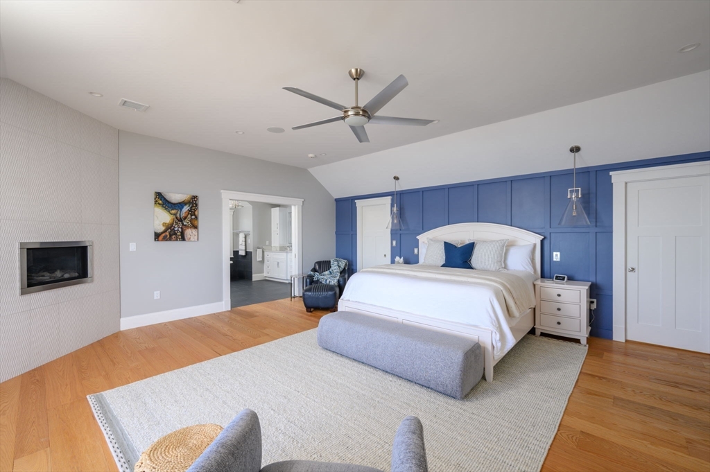 171 Otis Street Hingham, MA 02043 - Photo 14 of 29 a bedroom with a large bed and a chandelier