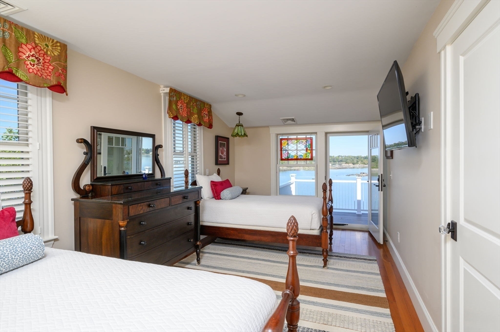 171 Otis Street Hingham, MA 02043 - Photo 17 of 29 a bedroom with a bed and wooden floor