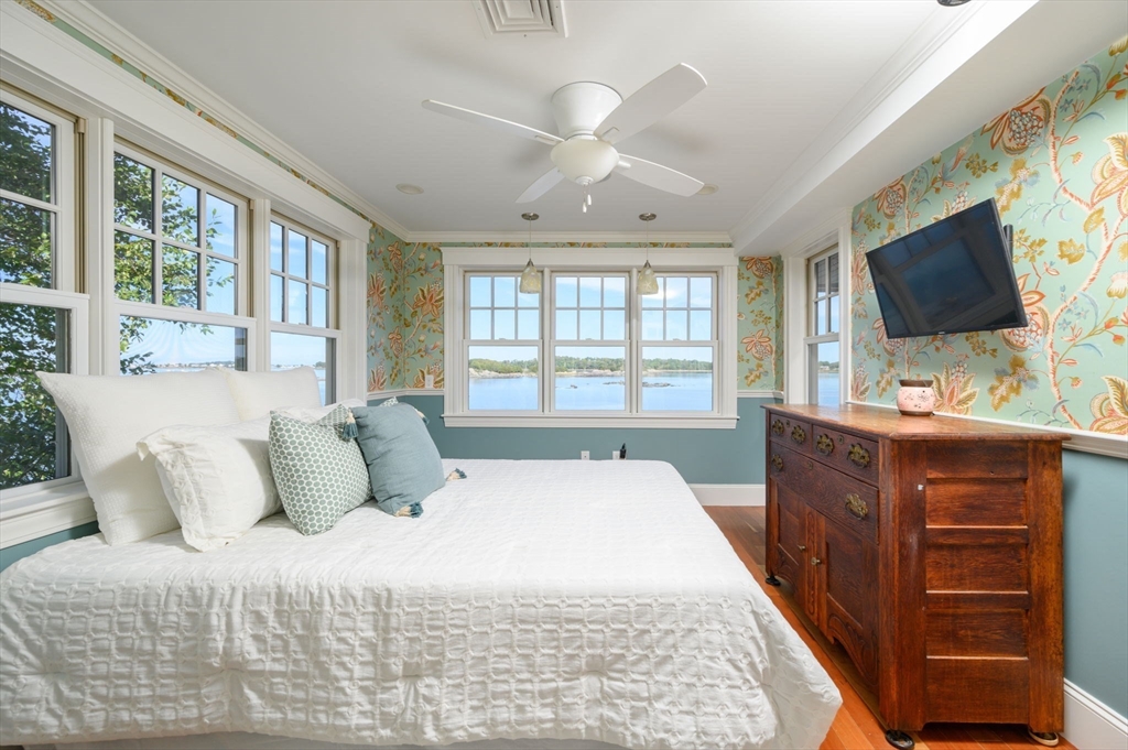 171 Otis Street Hingham, MA 02043 - Photo 18 of 29 a bedroom with a large bed and a flat screen tv