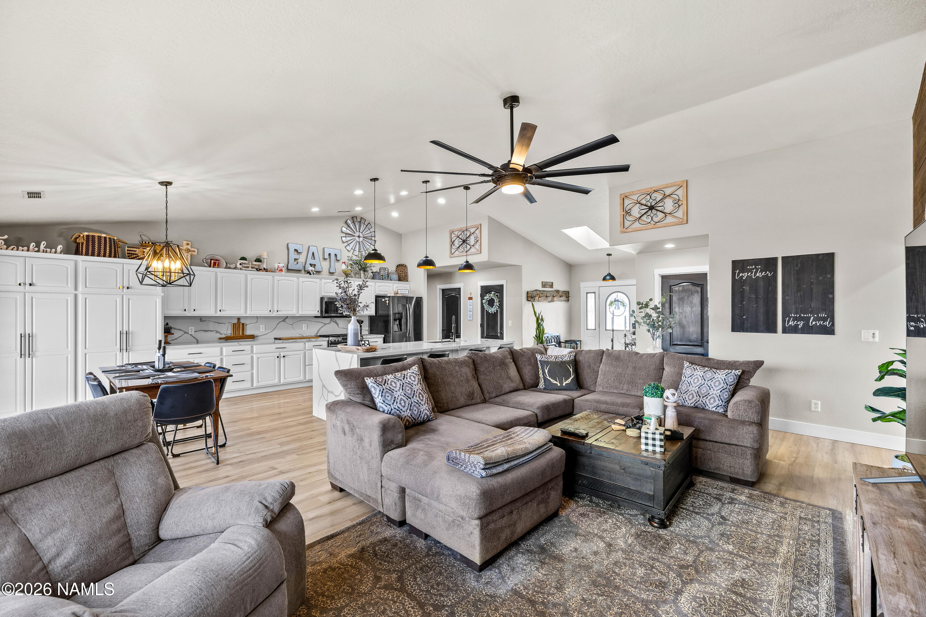 9534 North Aldrich Road Flagstaff, AZ 86004 - Photo 12 of 31 a living room with furniture kitchen view and a chandelier