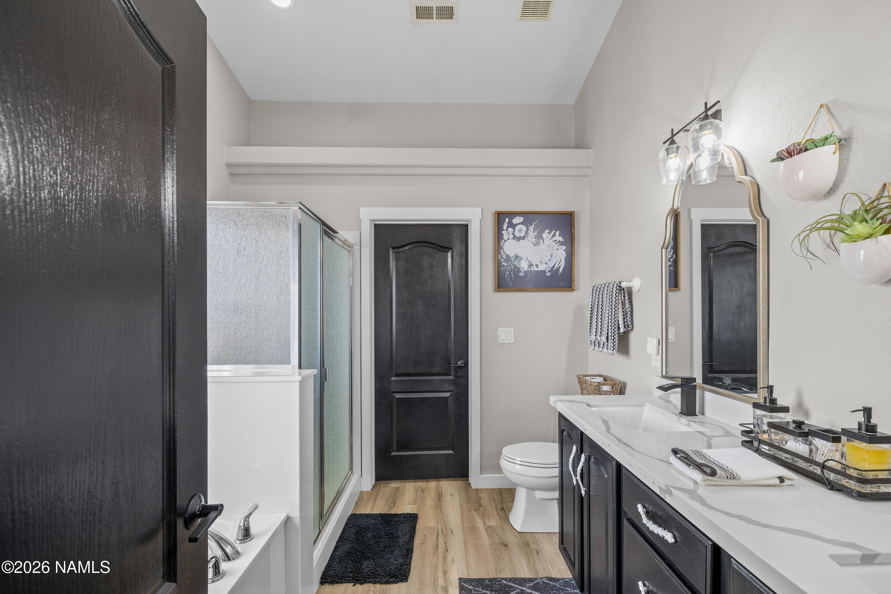 9534 North Aldrich Road Flagstaff, AZ 86004 - Photo 22 of 31 a bathroom with a double vanity sink a toilet and shower