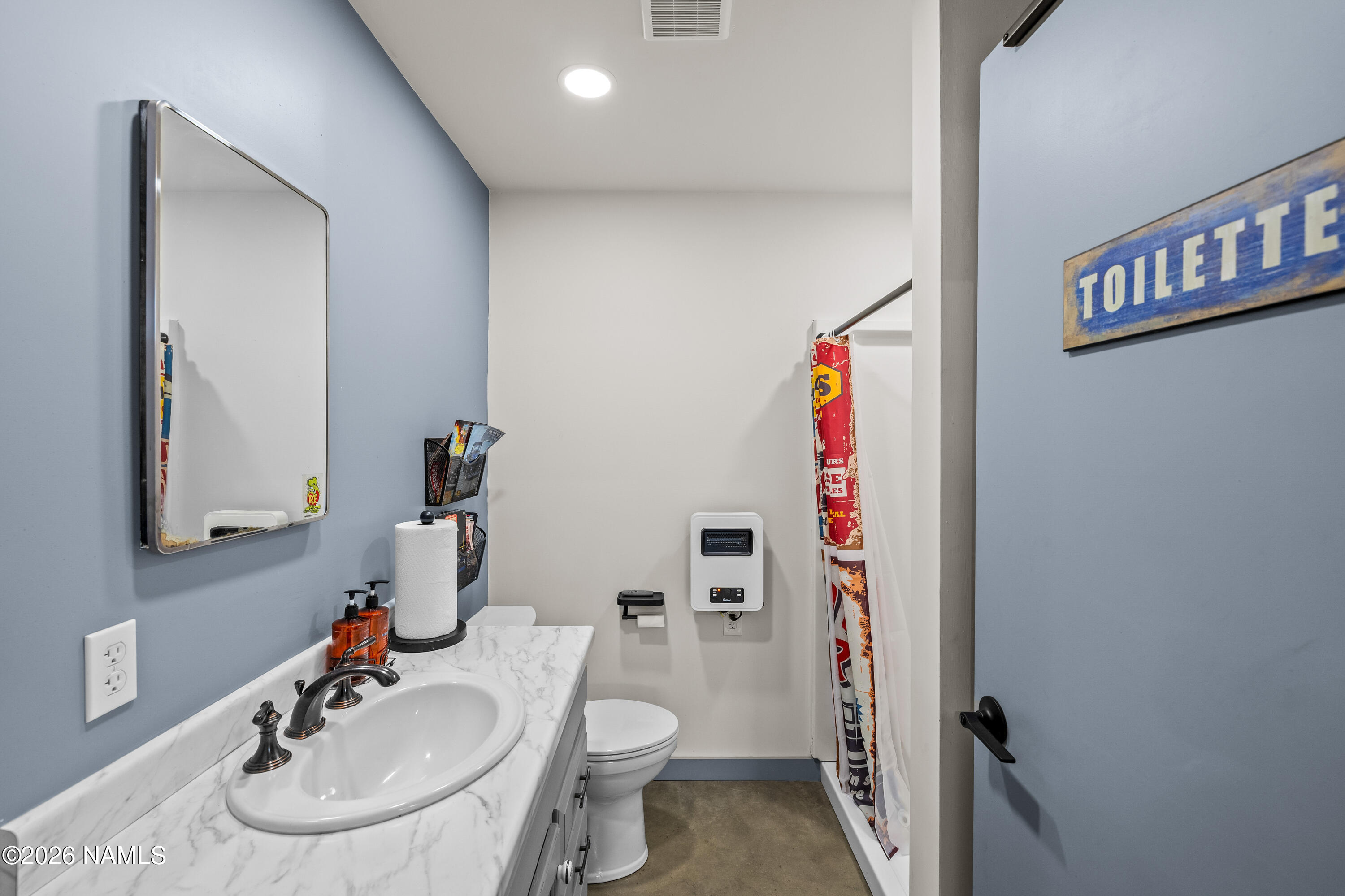 9534 North Aldrich Road Flagstaff, AZ 86004 - Photo 28 of 31 a bathroom with a sink toilet and a mirror