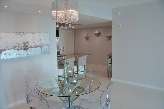 a kitchen with kitchen island a counter top space a sink and stainless steel appliances