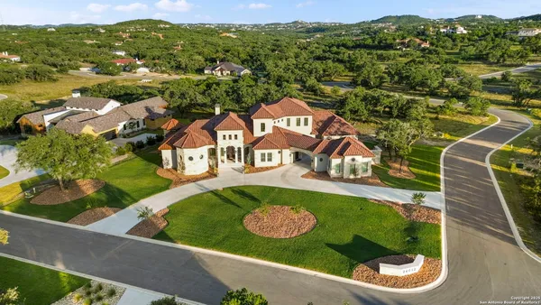 an aerial view of residential houses and outdoor space