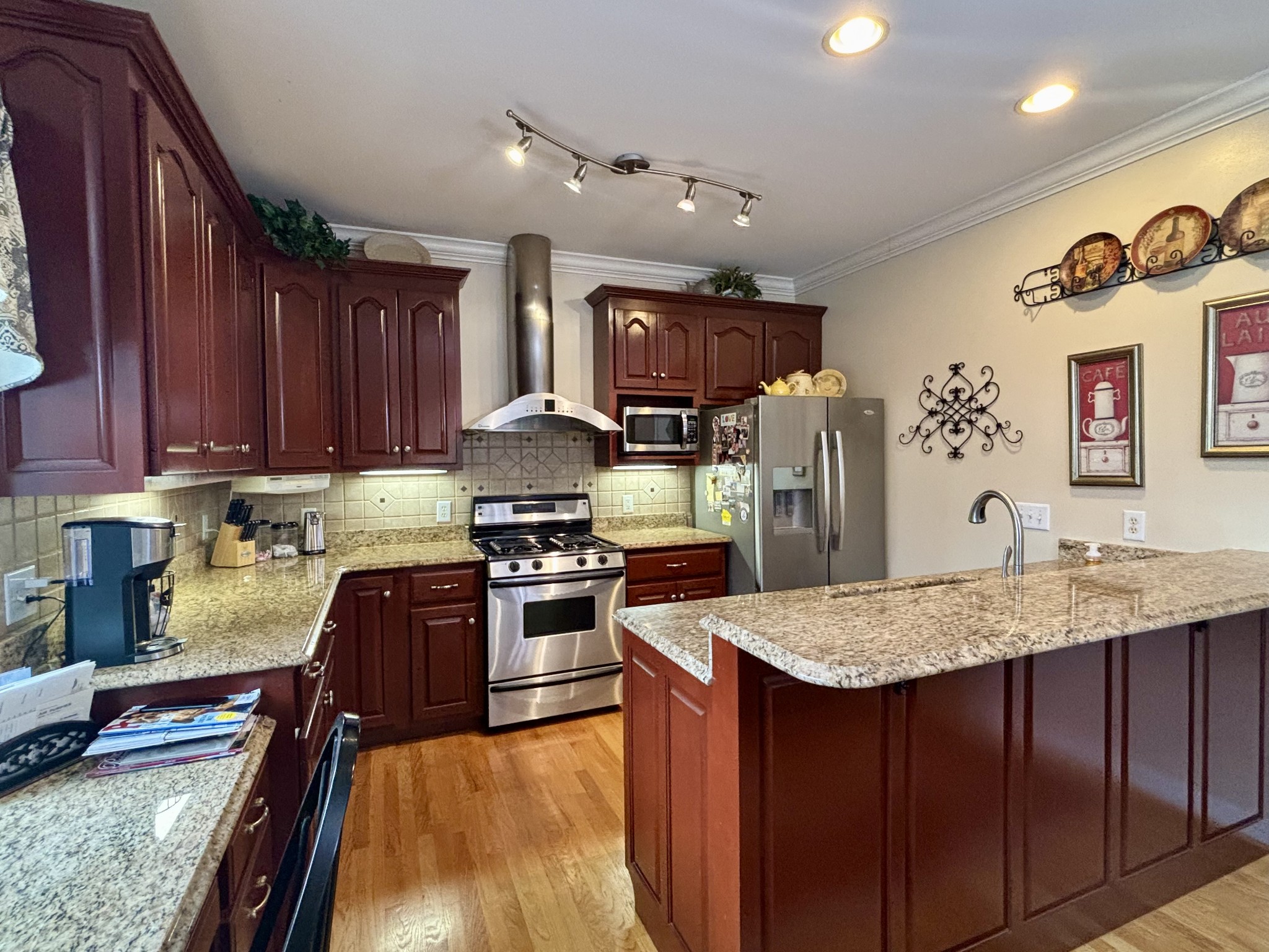 498 Dearman Street Smithville, TN 37166 - Photo 15 of 39 a kitchen with stainless steel appliances granite countertop wooden cabinets a stove top oven a sink and dishwasher