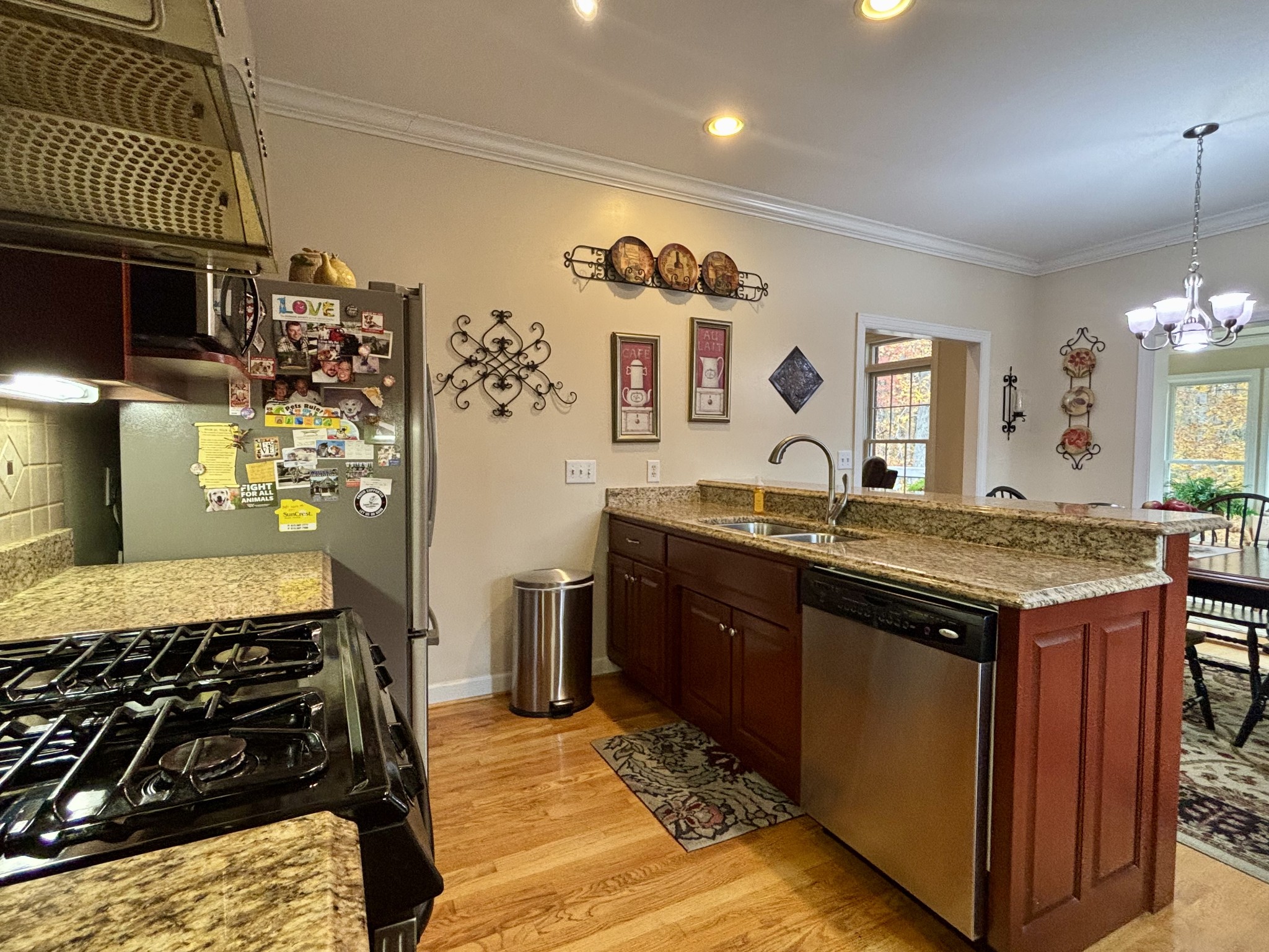 498 Dearman Street Smithville, TN 37166 - Photo 17 of 39 a kitchen with granite countertop a sink stove and cabinets