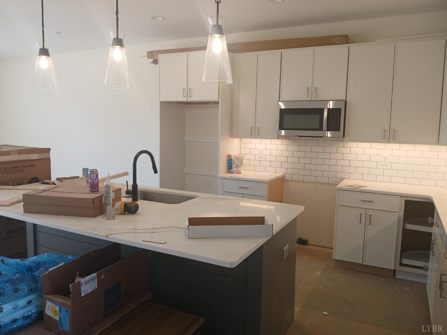 14 Faith Court Rustburg, VA 24588 - Photo 5 of 20 a kitchen with sink a microwave a stove and cabinets