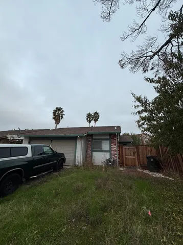 a backyard of a house with table and chairs