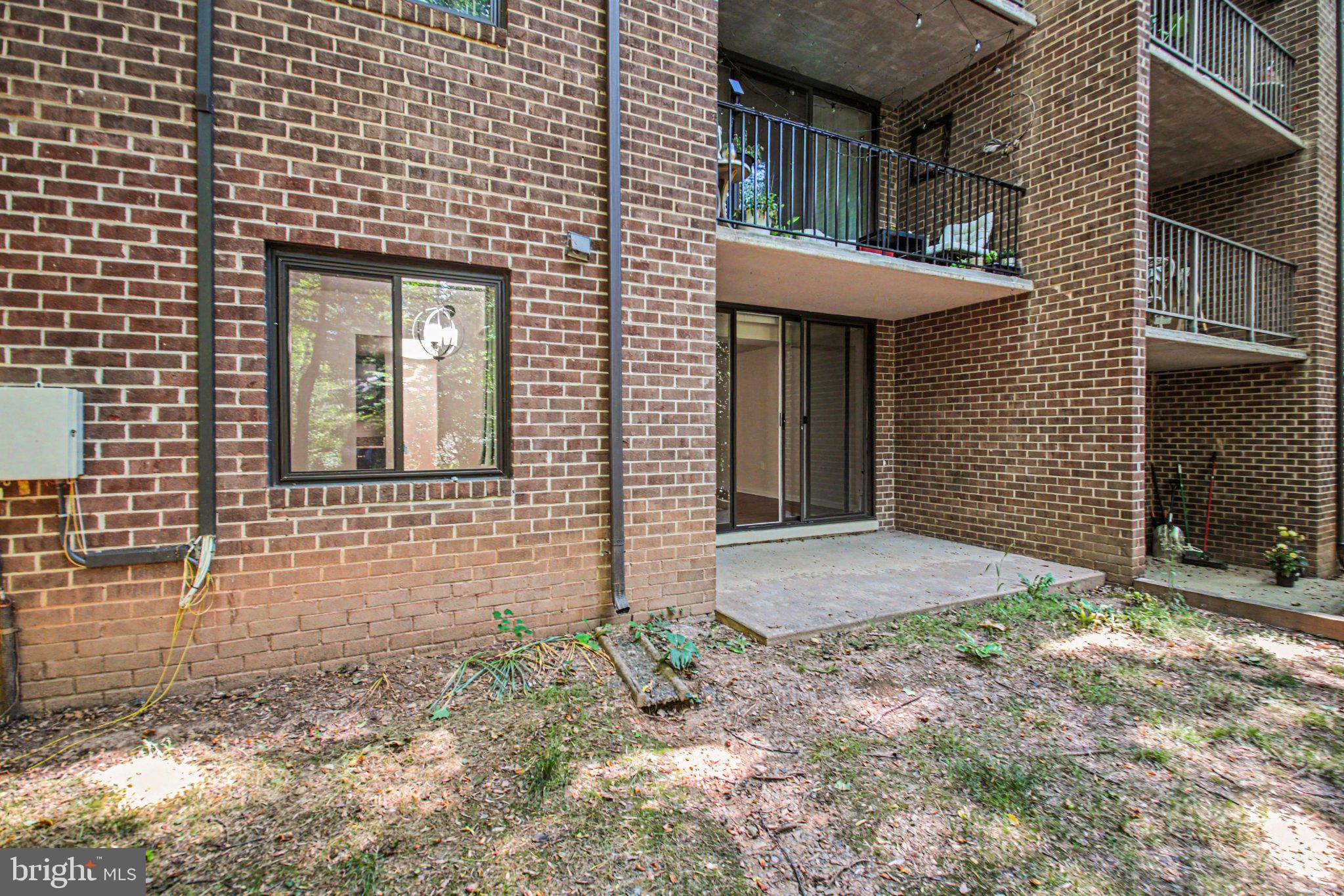 1417 Northgate Square, Unit 1A Reston, VA 20190 - Photo 21 of 24 Charming brick facade with serene patio.