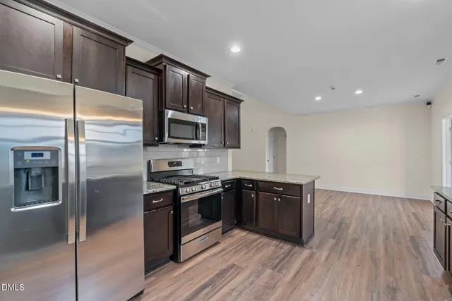 a kitchen with a sink and wooden cabinets