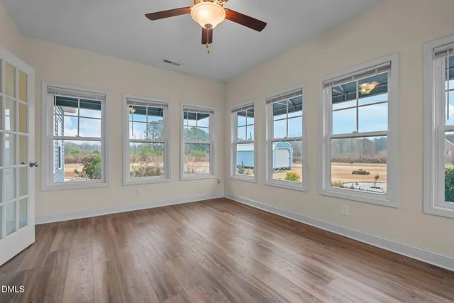wooden floor in an empty room with a window