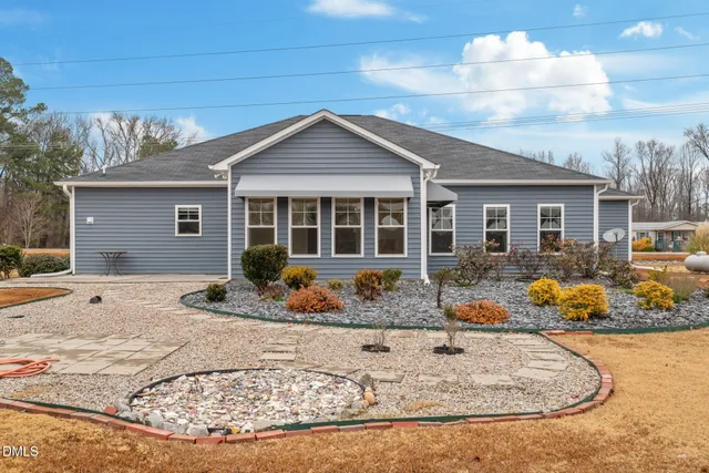 a view of a swimming pool with an outdoor seating and a yard