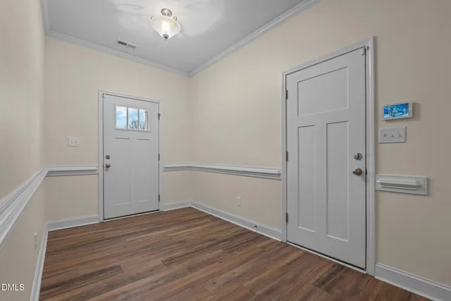 an empty room with wooden floor and chandelier fan