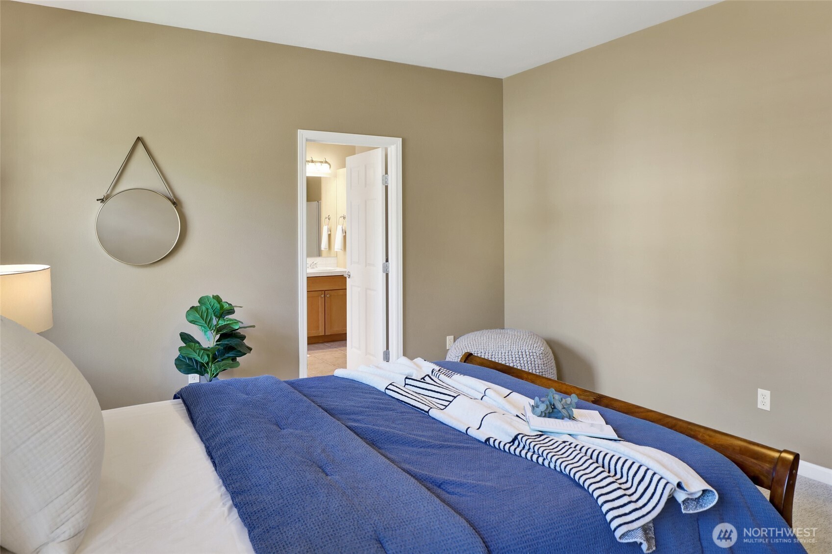 940 Nevada Street Bellingham, WA 98229 - Photo 20 of 31 a bedroom with a bed and a chandelier