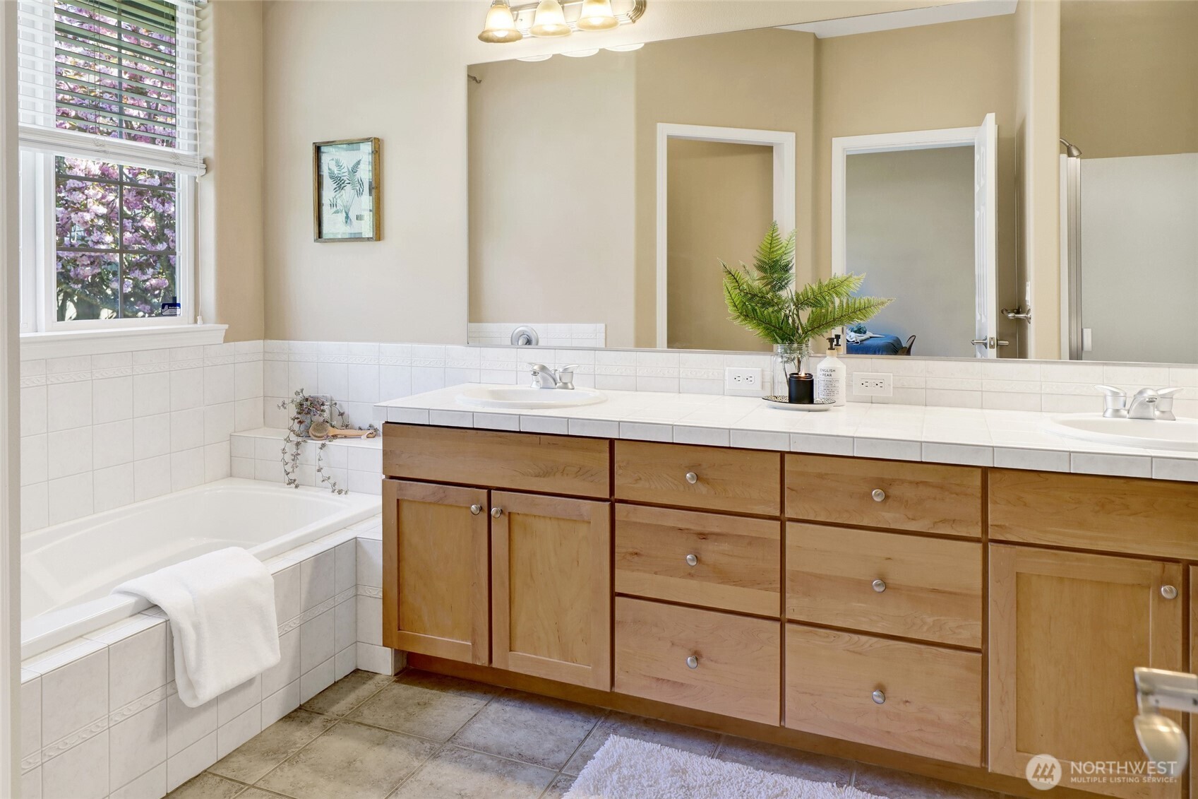 940 Nevada Street Bellingham, WA 98229 - Photo 22 of 31 a bathroom with a sink double vanity granite tub and a mirror