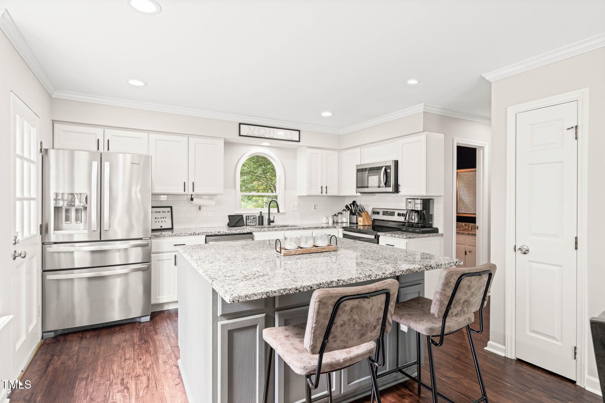 21 Cedar Hill Drive Durham, NC 27713 - Photo 11 of 45 a kitchen with stainless steel appliances granite countertop a refrigerator a stove a sink dishwasher and white cabinets with wooden floor