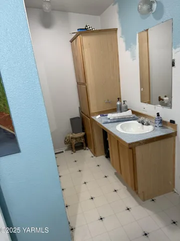 a bathroom with a sink and a mirror