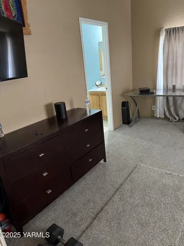 a room with a dresser and a window