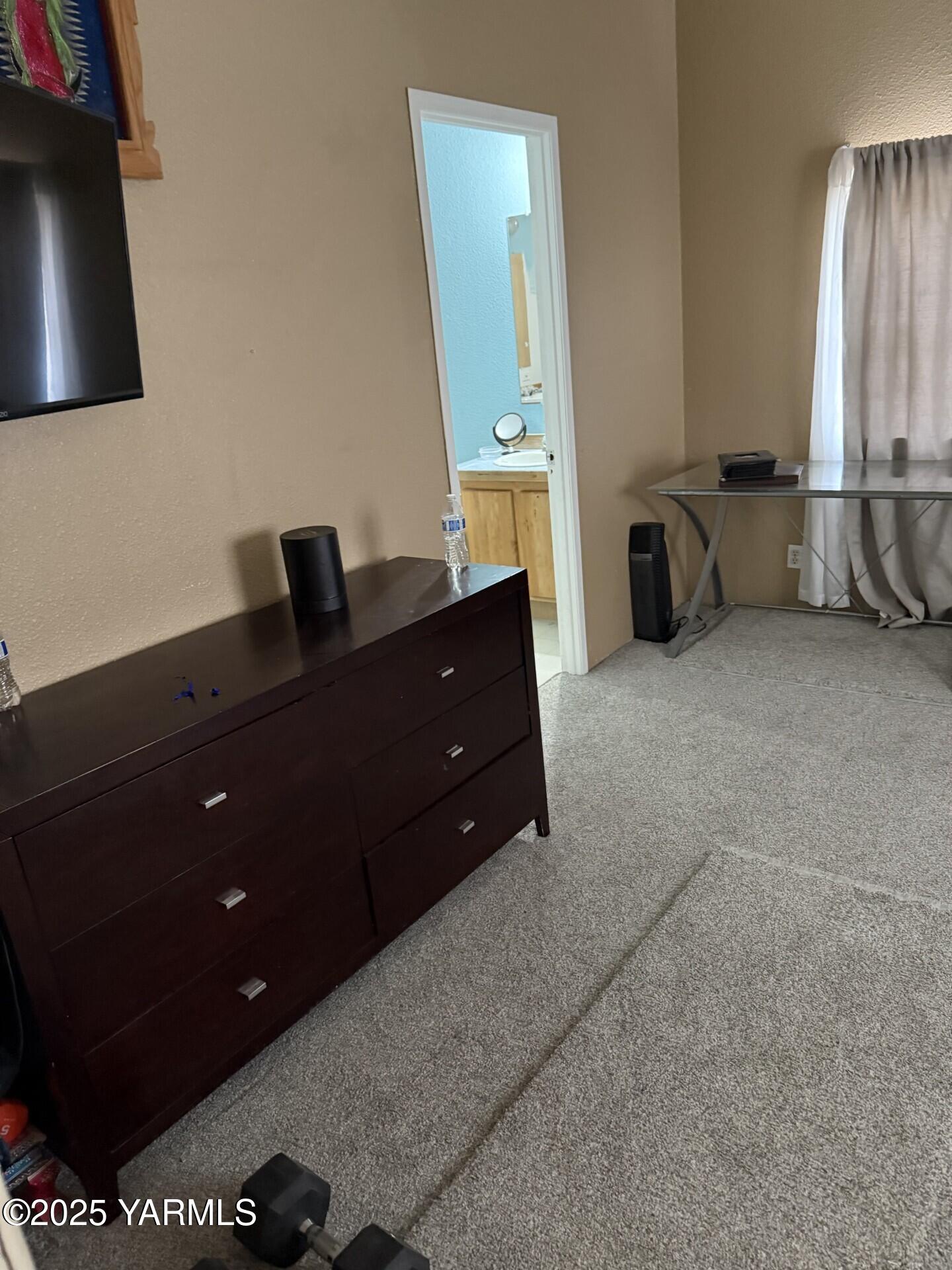 605 Dean Avenue Granger, WA 98932 - Photo 18 of 27 a room with a dresser and a window