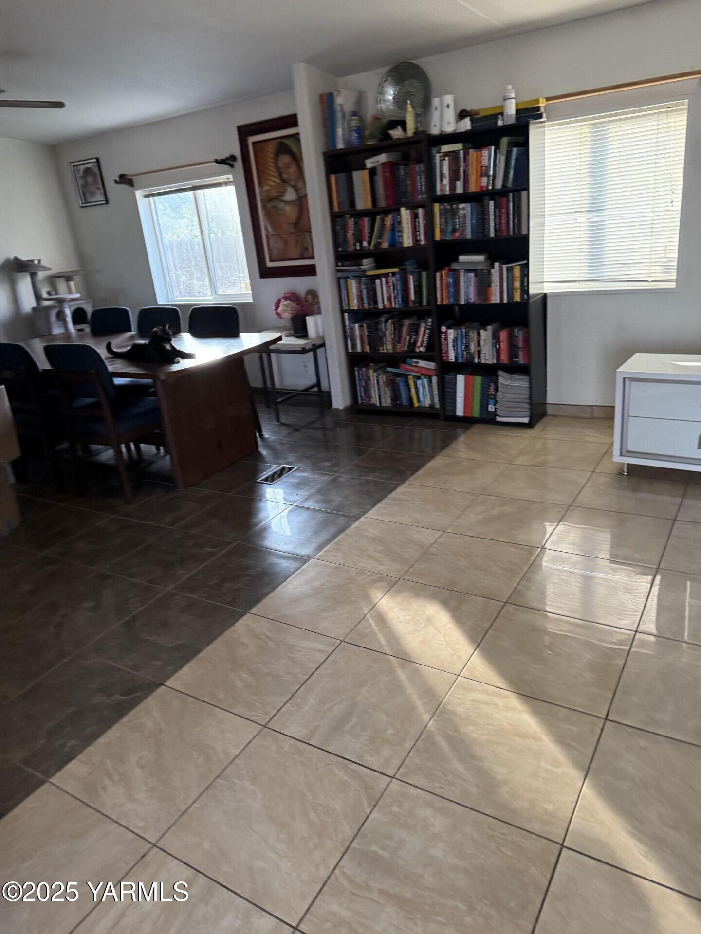 605 Dean Avenue Granger, WA 98932 - Photo 4 of 27 a living room with furniture a bookshelf and a window