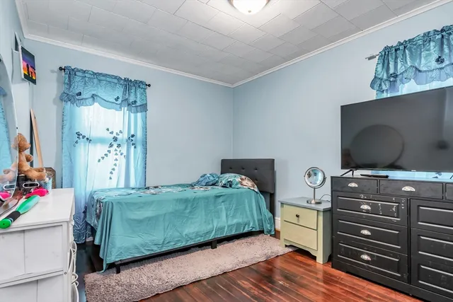 a bedroom with a bed and flat screen tv