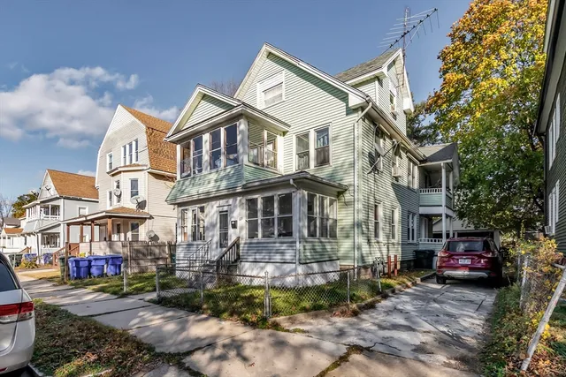 a front view of a residential apartment building with a yard