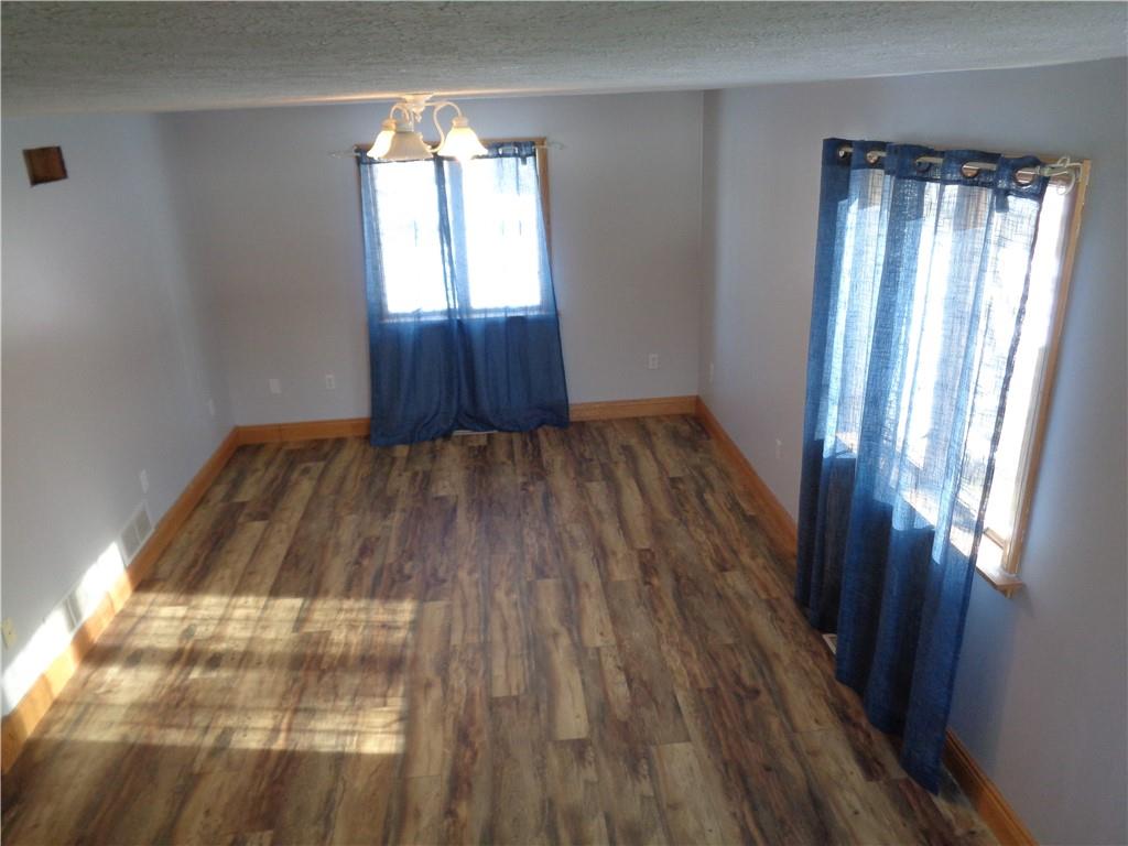 129 Kinsman Road Jamestown, PA 16134 - Photo 8 of 25 a view of empty room with wooden floor and fan