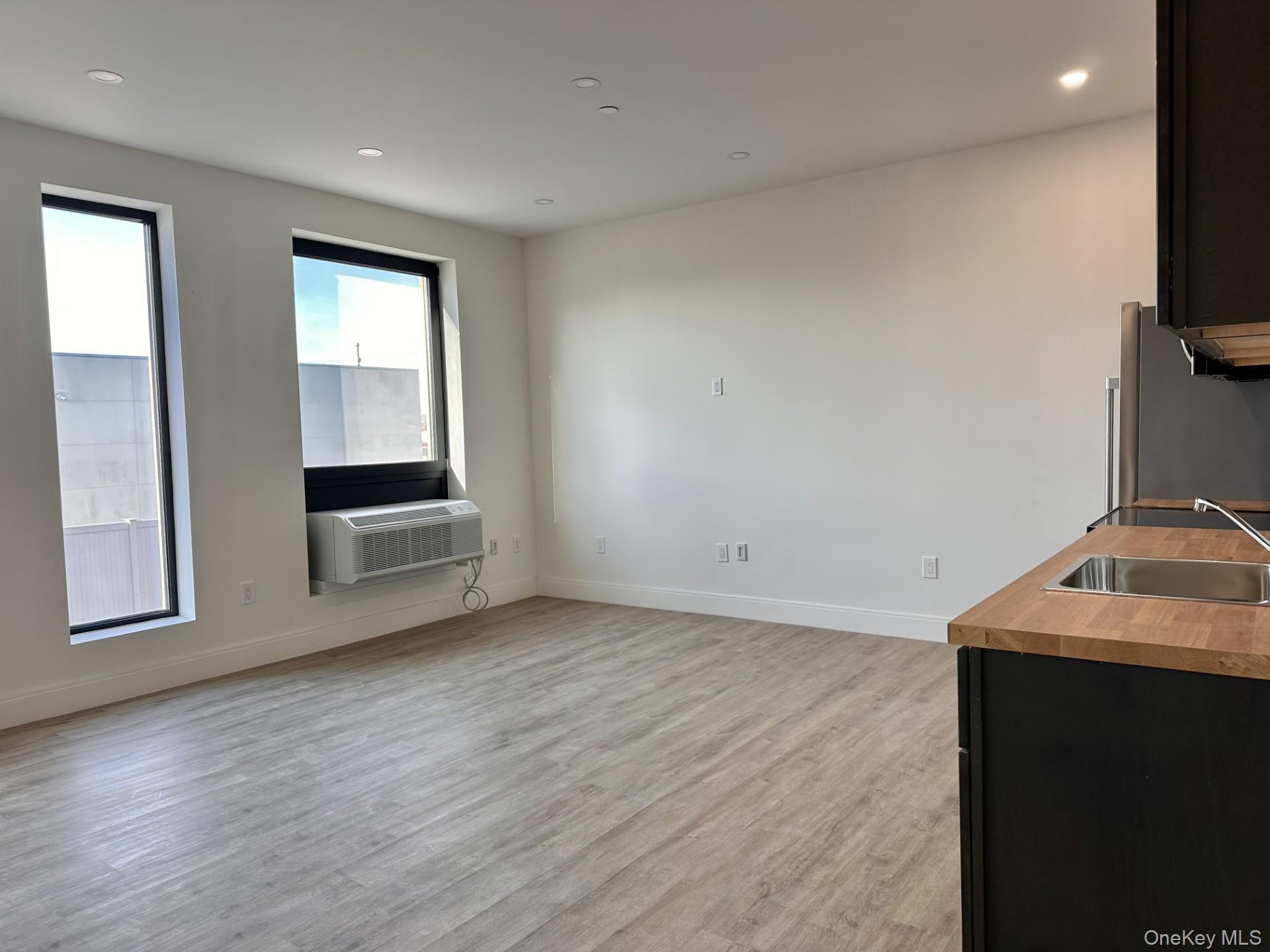 Unfurnished living room featuring recessed lighting and light wood-style flooring