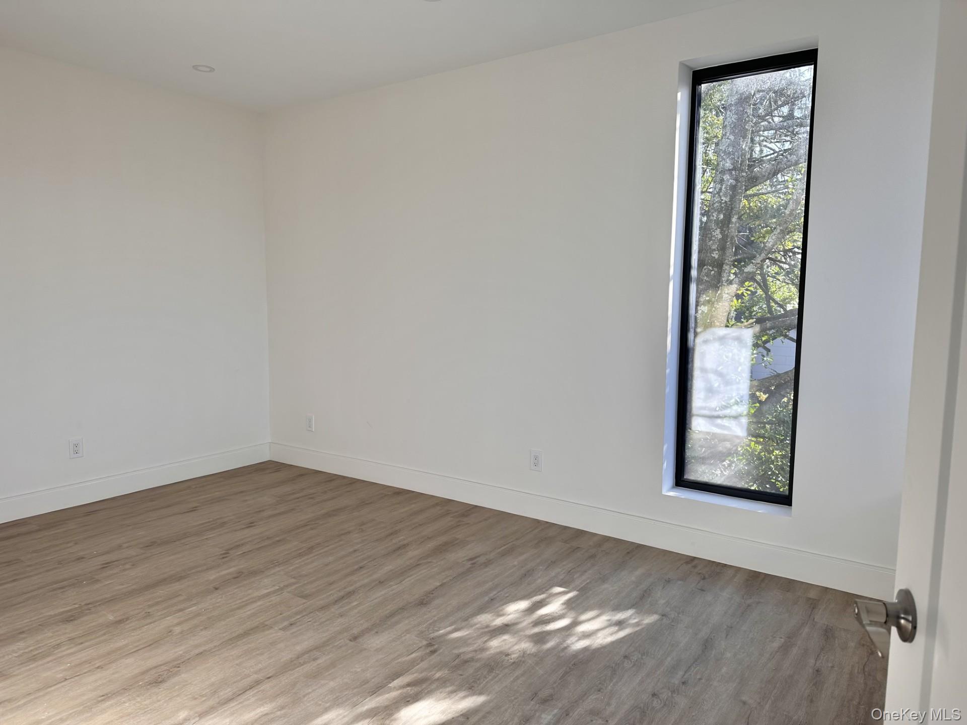 362 West Merrick Road, Unit 207 Valley Stream, NY 11580 - Photo 4 of 7 Spare room with wood finished floors
