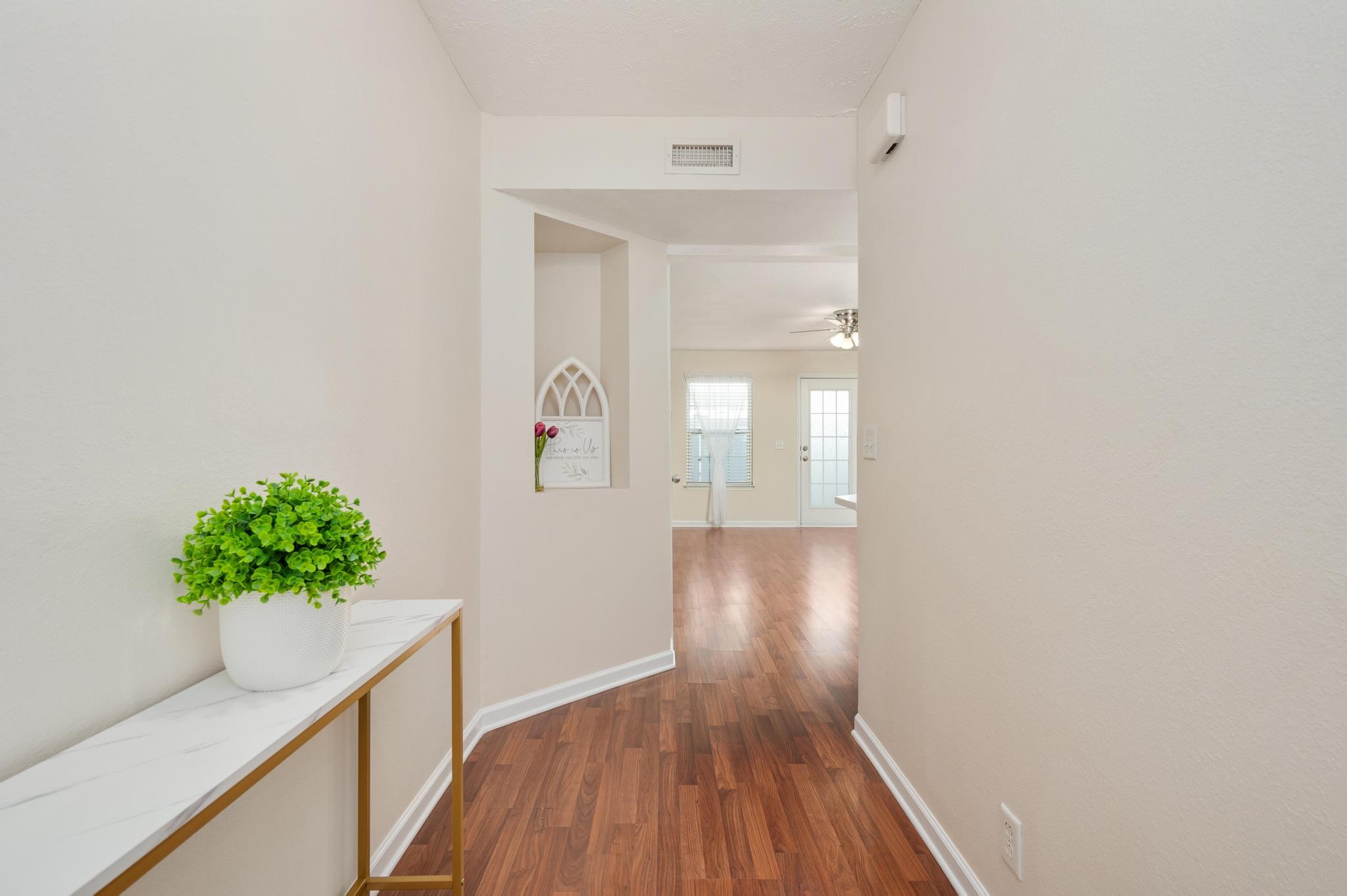 3016 London View Murfreesboro, TN 37128 - Photo 3 of 19 a view of a hallway with wooden floor and a potted plant