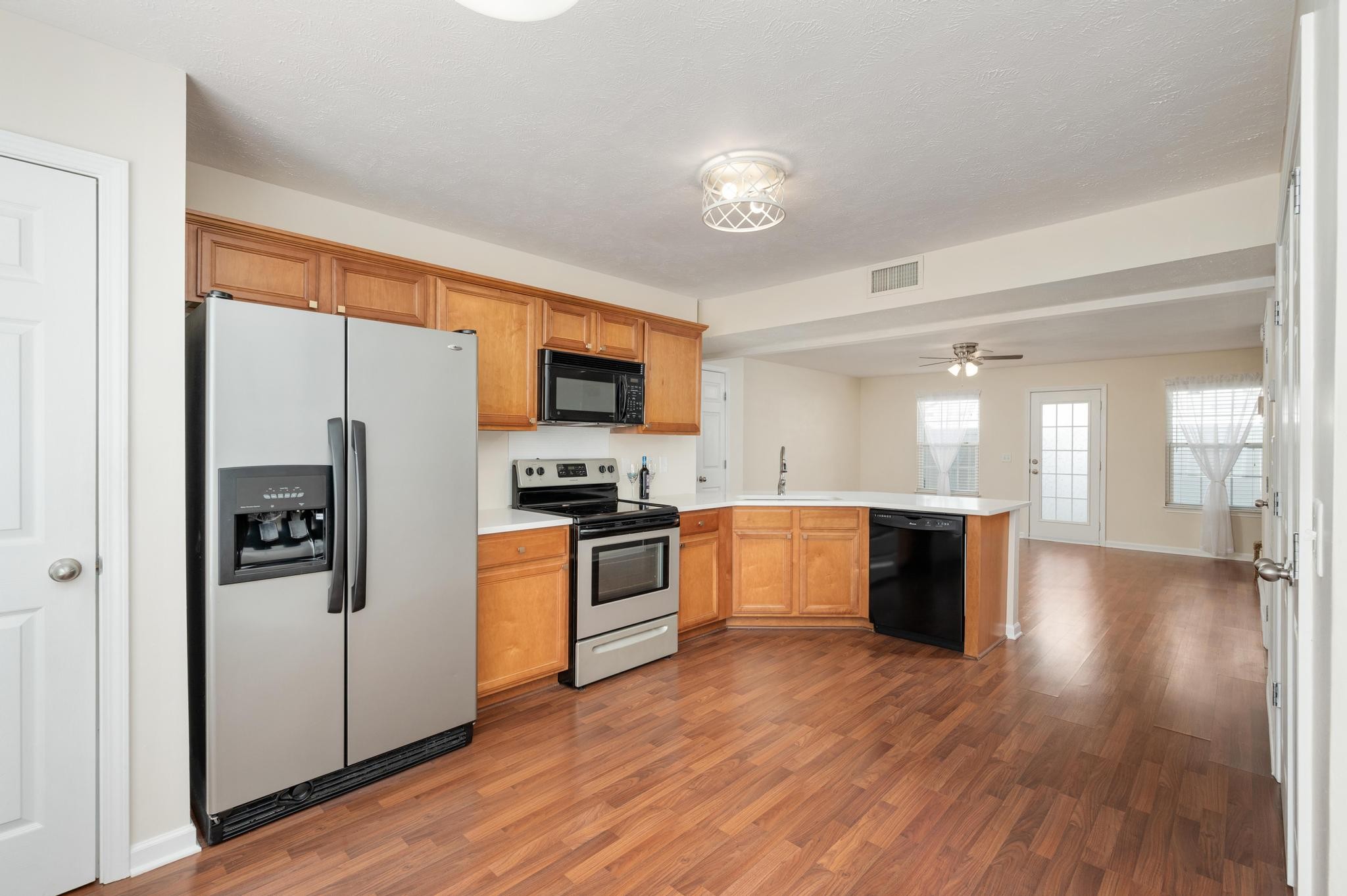 3016 London View Murfreesboro, TN 37128 - Photo 9 of 19 a kitchen with a refrigerator a stove top oven a sink dishwasher and wooden floor